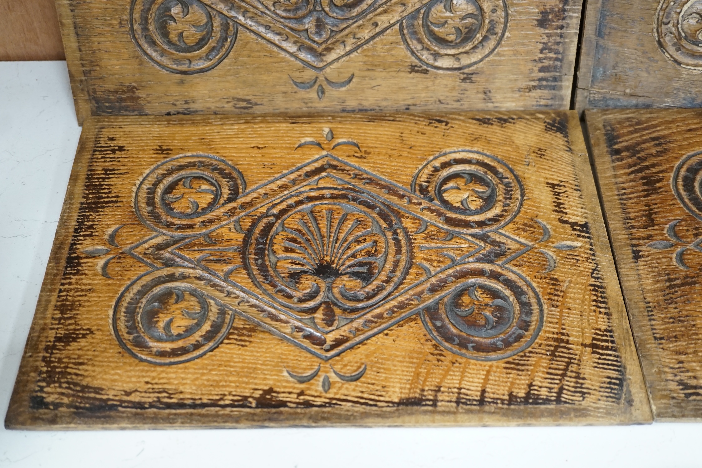 A set of four 18th century carved oak panels, 37cm x 25cm. Condition - two have splits